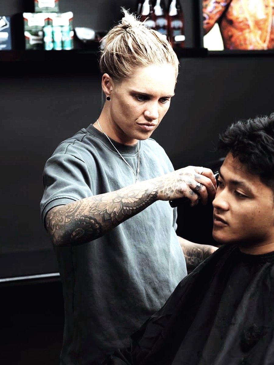 A barber lining up a client at Abra & Co